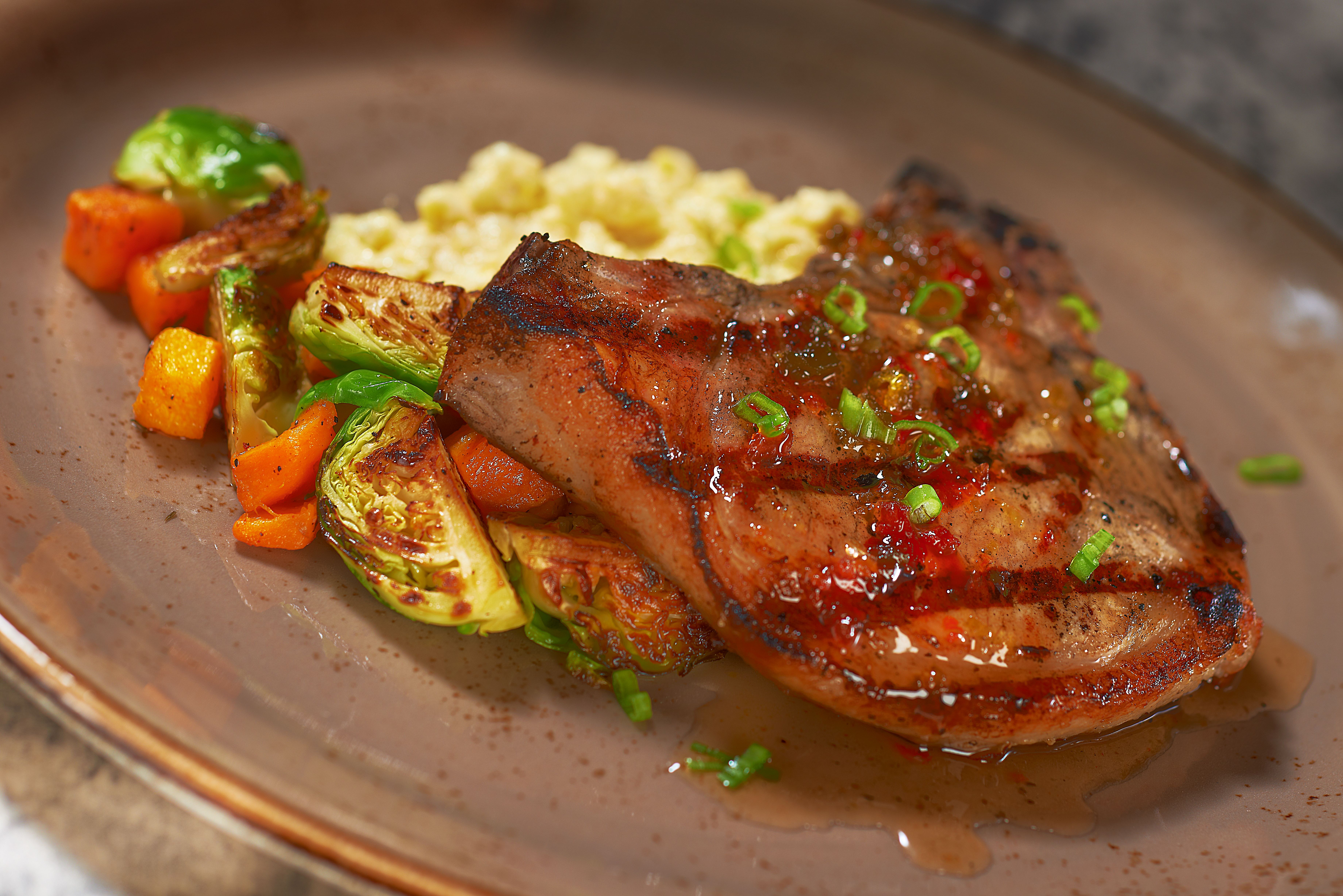 Pork with vegetables and grits. 